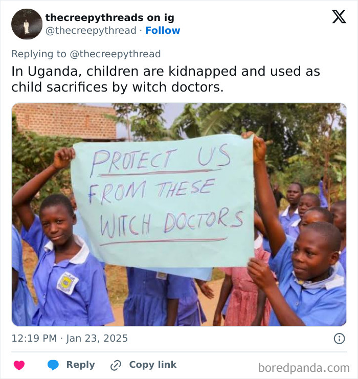 Children in Uganda hold a sign protesting witch doctors in a disturbing spooky facts about our world.