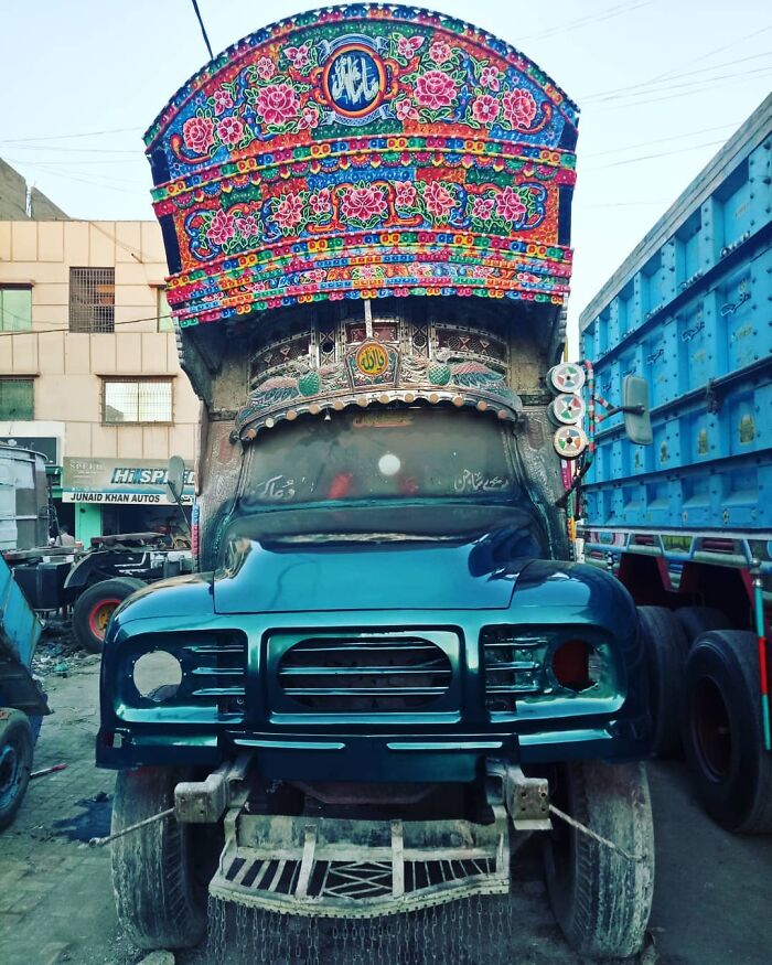 Colorful truck with intricate patterns and floral art, showcasing stunning works of art on vehicles by this artist.